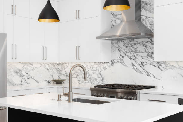 istock A kitchen detail with white cabinets and marble countertops. 1530769752