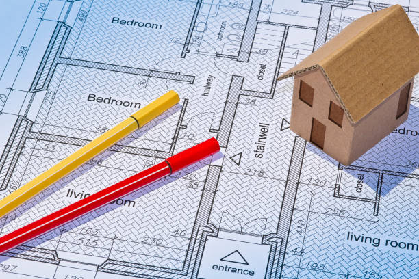 istock Building activity concept with residential building project printed on paper and building permit with home model 1530776281