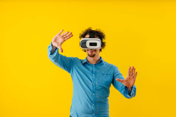 istock Young Man Playing A Virtual Reality Game In Front Of A Yellow Wall 1530776521