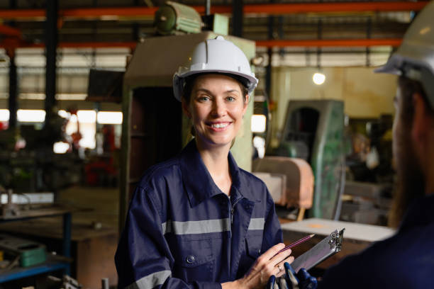 istock Mechanical engineers repairing engine machine at factory 1530776834