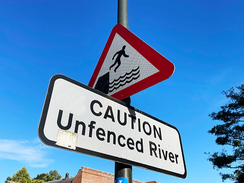 Warning signs by a river