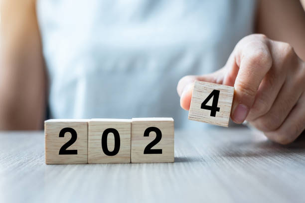 istock hand flipping block 2023 to 2024 text on table. Resolution, strategy, plan, goal, motivation, reboot, business and New Year holiday concepts 1530779228