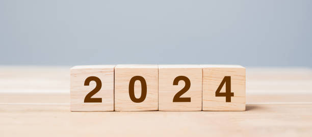 istock wooden cube block with 2024 text on table background. Resolution, plan, review, goal, start and New Year holiday concepts 1530779407