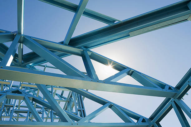 New home construction framing. New residential construction home metal framing against a blue sky hand cropping photos stock pictures, royalty-free photos & images