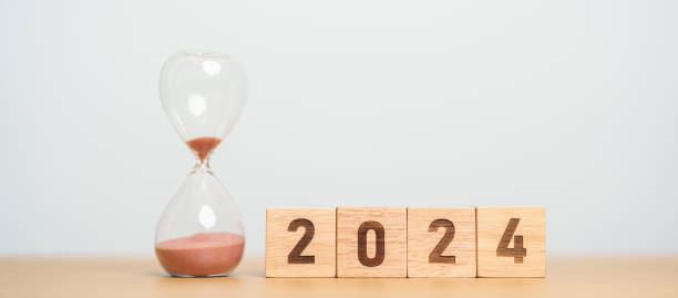 istock 2024 text with hourglass on table. Resolution, time, plan, goal, motivation, reboot, countdown  and New Year holiday concepts 1530784249