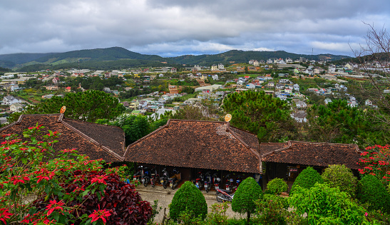 Aerial view of old houses with cityscape background in Dalat, Vietnam.