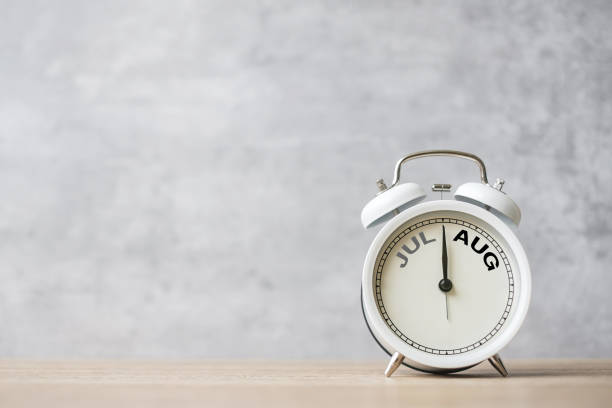 istock Hello August  Changed from July month with vintage alarm clock on table background. Calendar, Monthly, New Start, Resolution, Goals, Plan, Action and Mission Concept 1530789590