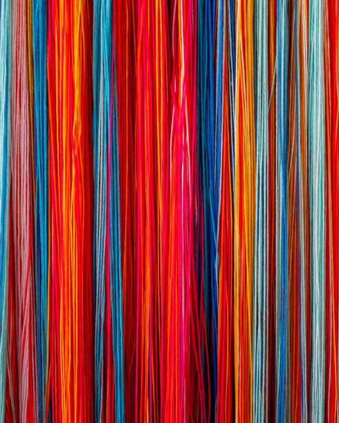 istock Retail shop display rack stocked with an array of colorful spools of thread 1530797754