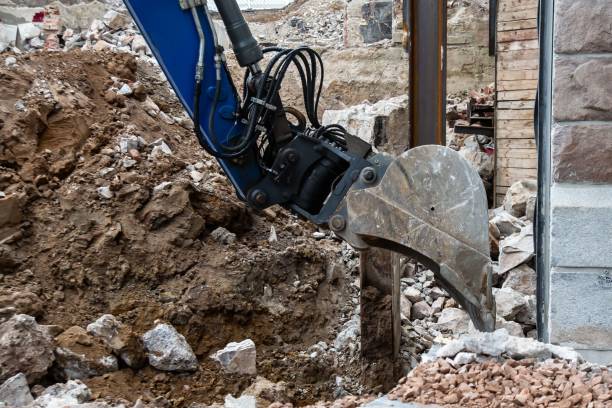 istock Blue digger digging a construction site with a pile of dirt and rocks 1530802833