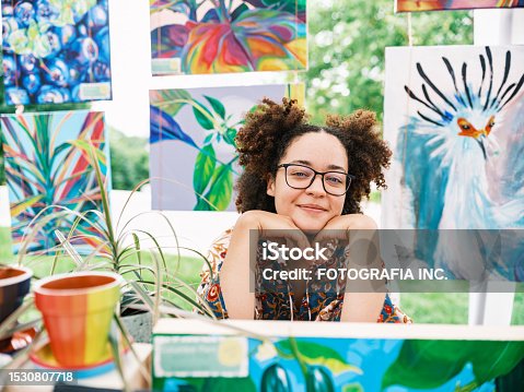 istock Young Latin woman artist selling her art at Outdoor Market 1530807718
