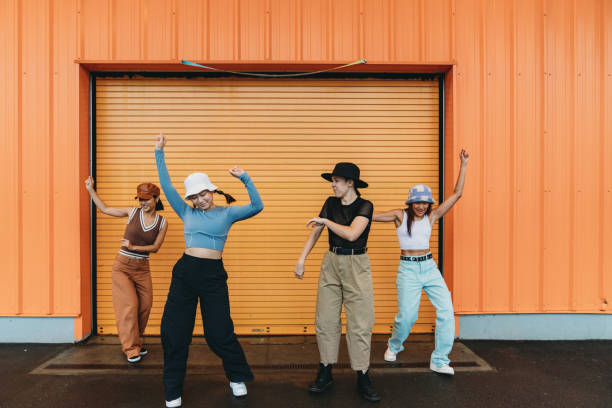 istock Cool dancers are having fun dancing against an orange wall 1530808585