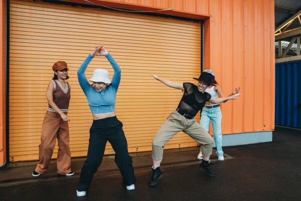 istock Cool dancers are having fun dancing against an orange wall 1530808620