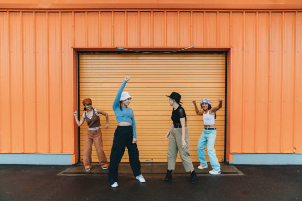 istock Cool dancers are having fun dancing against an orange wall 1530808628