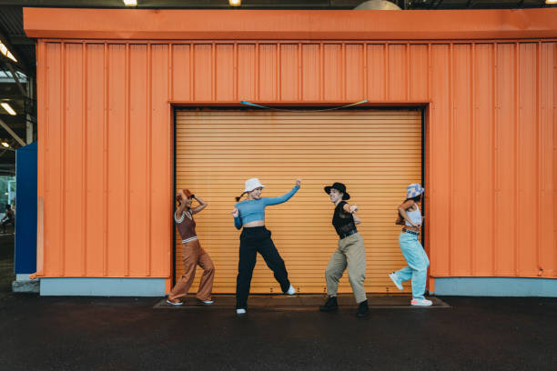 istock Cool dancers are having fun dancing against an orange wall 1530808644