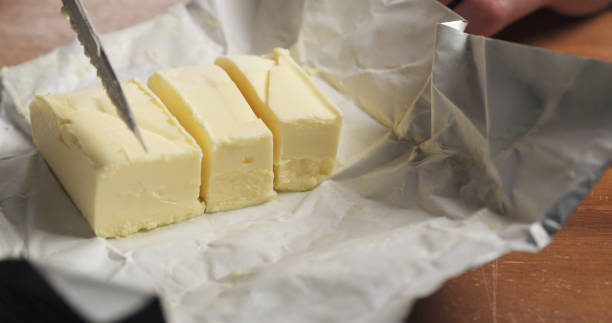 istock slicing butter with knife on kitchen closeup 1530809078