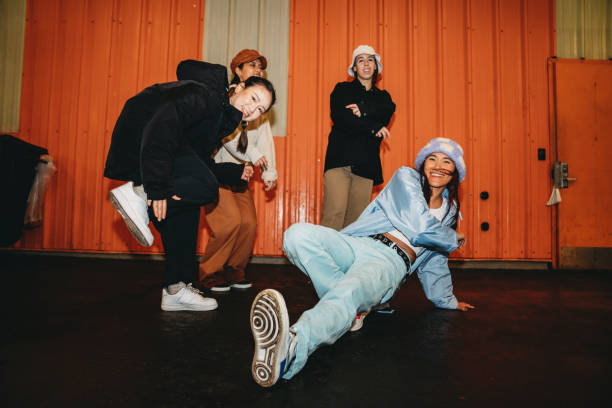 istock Cool dancers are having fun dancing against an orange wall 1530809359