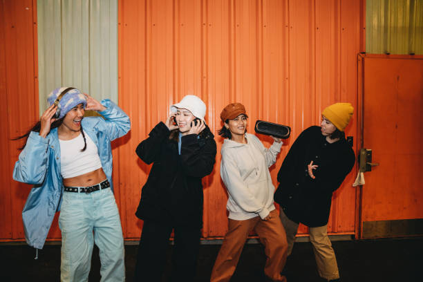 istock Cool dancers are having fun dancing against an orange wall 1530809505