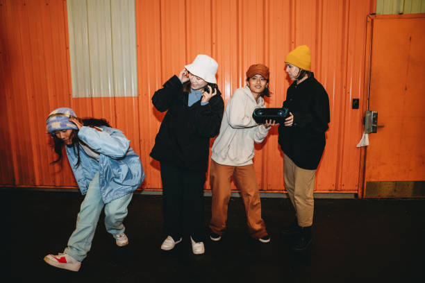 istock Cool dancers are having fun dancing against an orange wall 1530809513