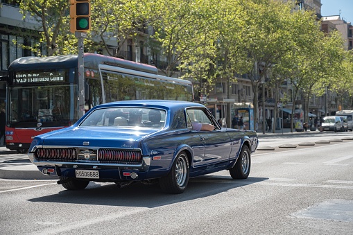 Barcelona, Spain – May 06, 2023: Nice American classic car, Mercury Cougar XR7 in blue color on the streets of the European city