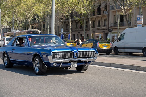 Barcelona, Spain – May 06, 2023: Nice American classic car, Mercury Cougar XR7 in blue color on the streets of the European city