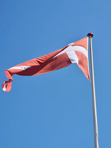 Danish flag Dannebrog in front of a blue sky