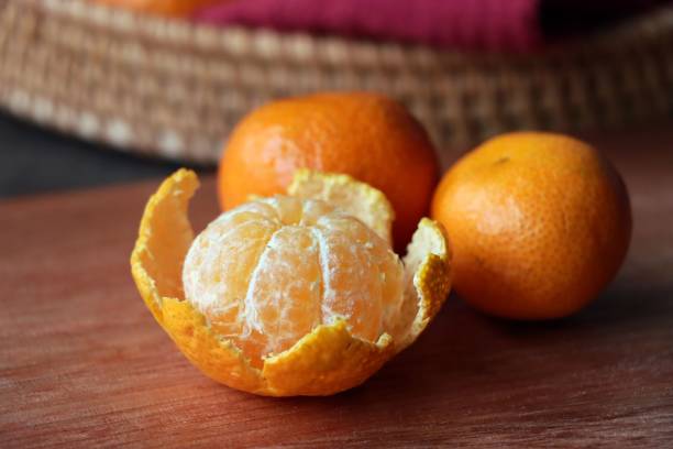 istock Fresh tangerines on a wooden board 1530819685