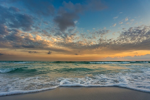 The sun setting over the horizon of an ocean expanse, Destin, Florida