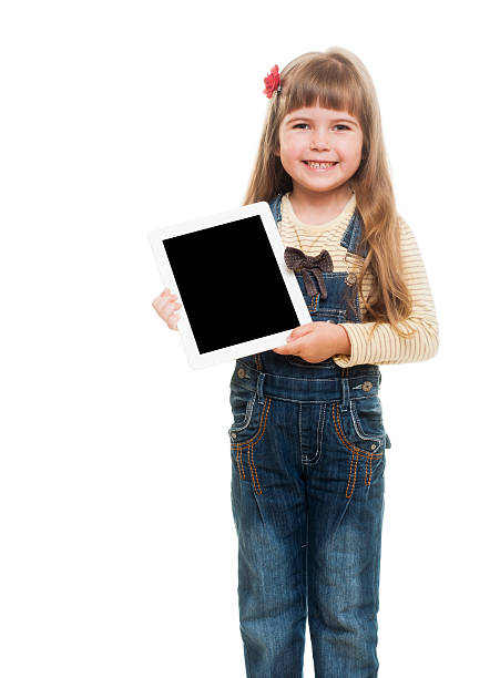 istock cute little girl posing in studio with white tablet gadget 153083911