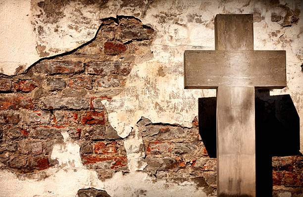 istock Cross and grunge wall on cemetery 153084101