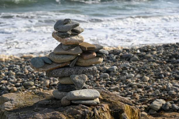 istock Stunning beach shore with stone stacked in a tower 1530846969