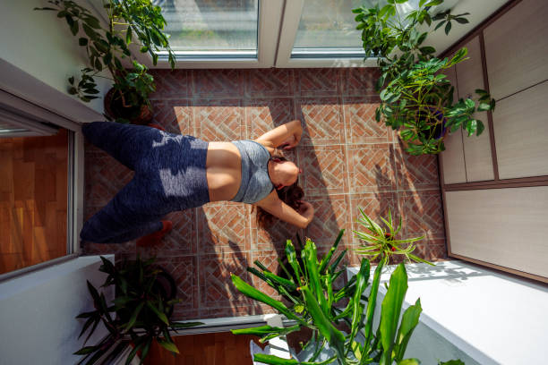 istock Woman doing yoga at home 1530850425