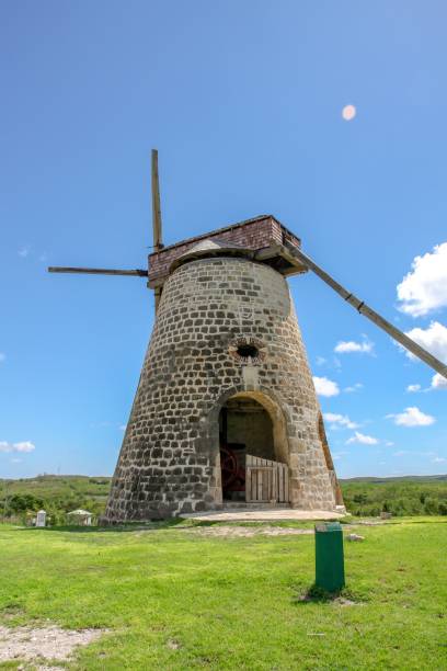istock Beautiful, old stone windmill set in a lush green field 1530861313