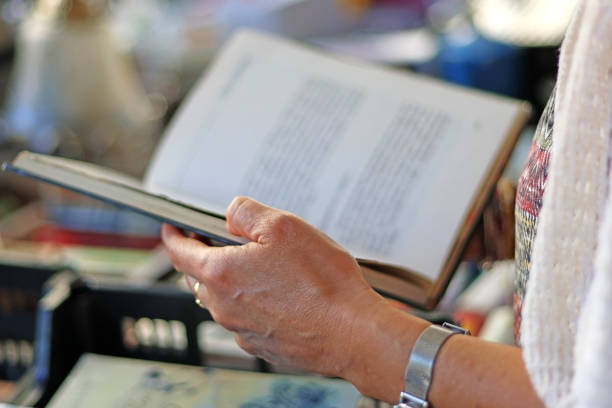A woman reading a book. Selective focus