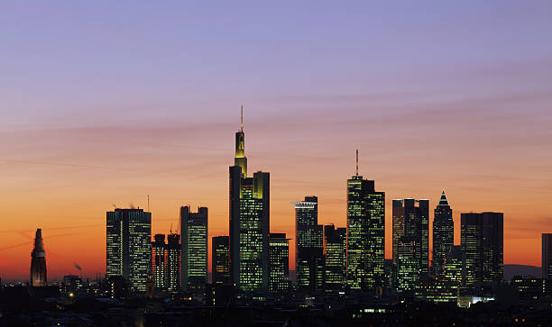 Frankfurt skyline with orange and purple sky  View at the financial district during a dramatic sunset. frankfurt skyline stock pictures, royalty-free photos & images