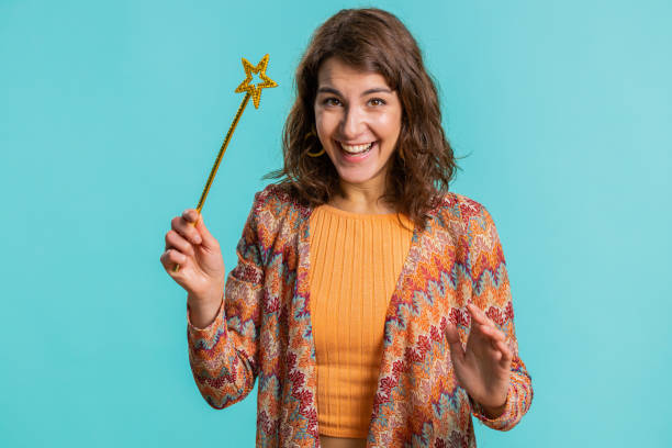 istock Magician witch young woman gesturing with magic wand making wish come true, casting magician spell 1530876839