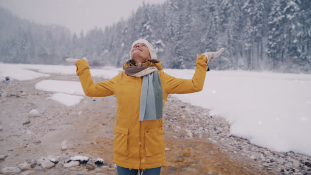 SLO MO Woman smiles as she enjoys a fresh air in wintry landscape