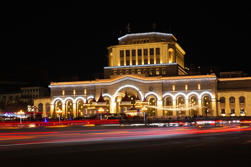 The Republic Square of Armenia decorated for Christmas, with light trails of cars on the road
