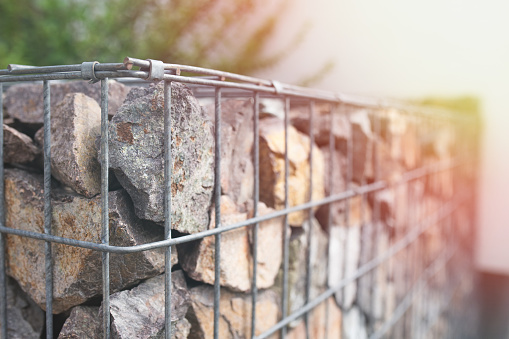 Close-up on gabion fence installed in the garden.
