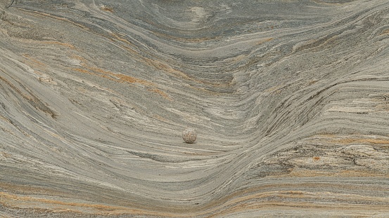 The granite stone waves as background with three round stones
