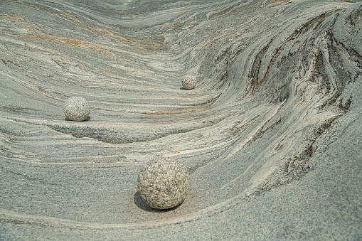 The granite stone waves as background with three round stones