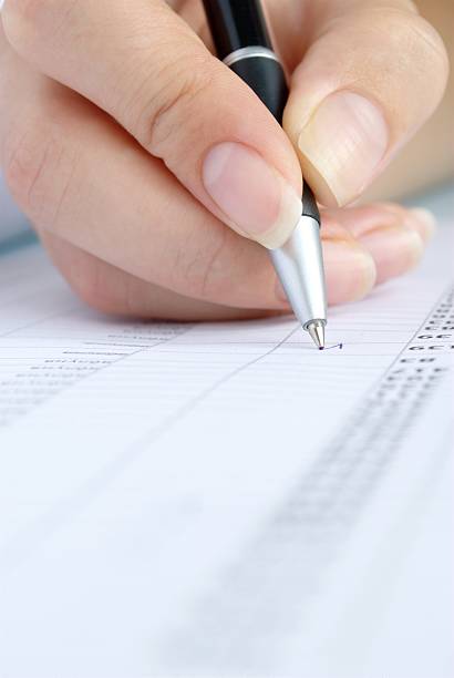 istock woman's hand and a pen 153089181