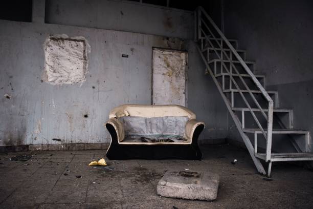 istock Abandoned room with an old sofa and a staircase. 1530892383