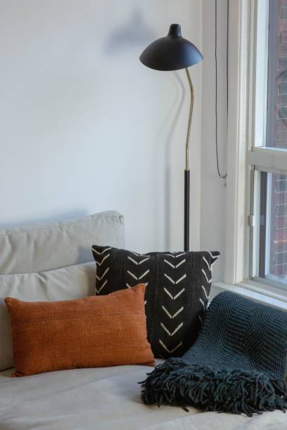 istock Comfortable living room interior featuring a cozy couch surrounded by various throw cushions 1530896888
