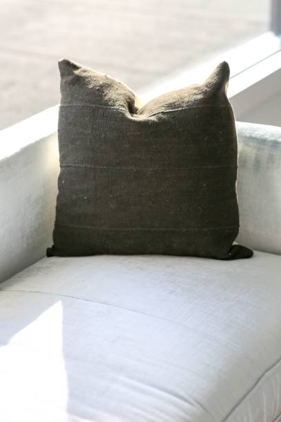 istock Modern white sofa with a cozy brown decorative pillow 1530897475