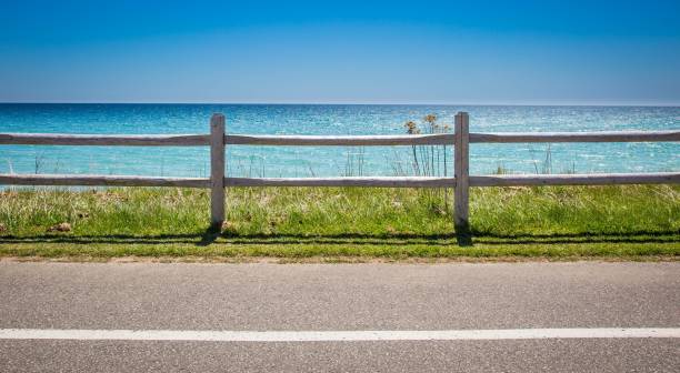 istock Fence by the beach with a beautiful water view behind it 1530897500
