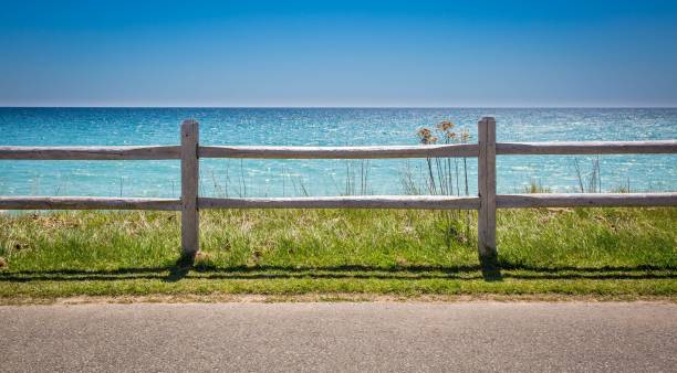 istock Fence by the beach with a beautiful water view behind it 1530897518
