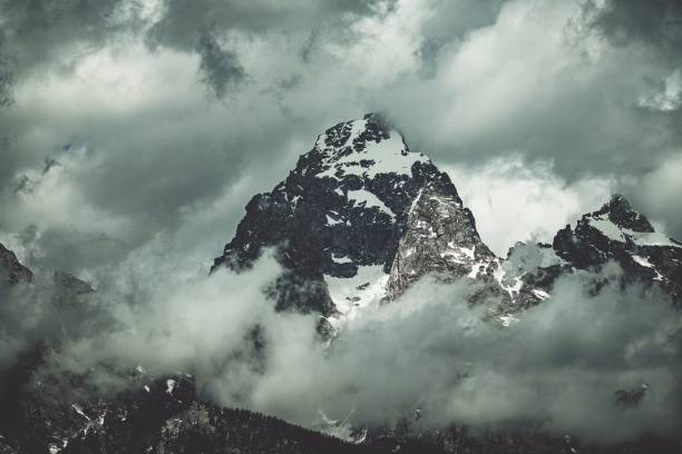 istock Majestic mountain range set against a grey, cloudy sky 1530898711