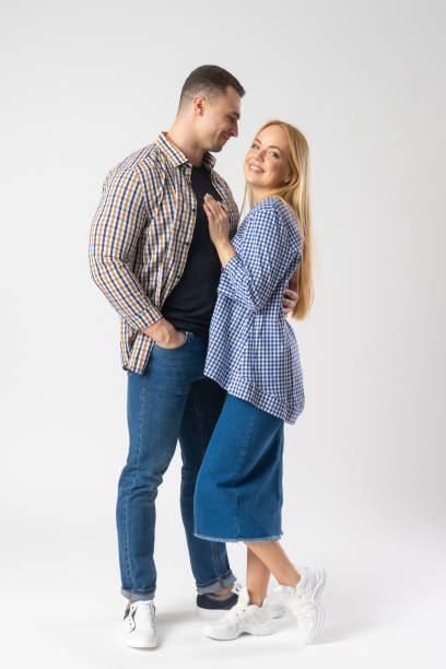istock Man and woman hugging while looking at the camera. A young married couple. 1530904465