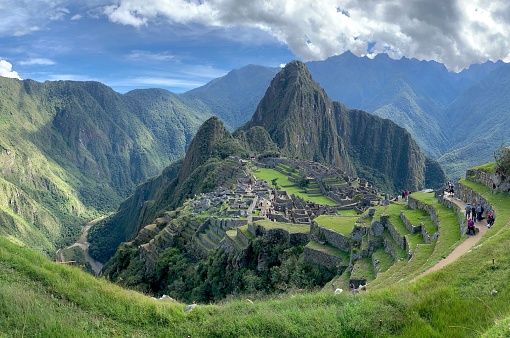 A scenic aerial view of Machu village nestled among the lush green hills in Peru