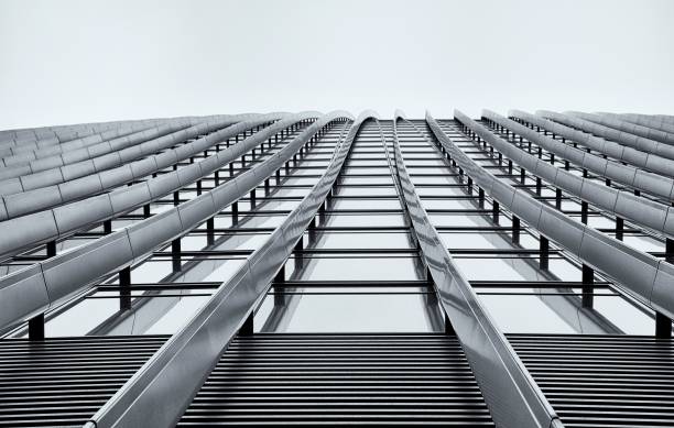 istock Low angle of a modern building against a cloudy sky in grayscale 1530909140